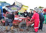 17_53_-_After_returning_to_the_pits_the_team_take_a_look_at_the_front_axle_damage.JPG