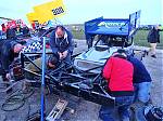 24_543_-_The_team_work_to_repair_the_front_end_after_Drew_was_hung_on_a_turn_1_fence_post_by_84_in_Heat_3.JPG