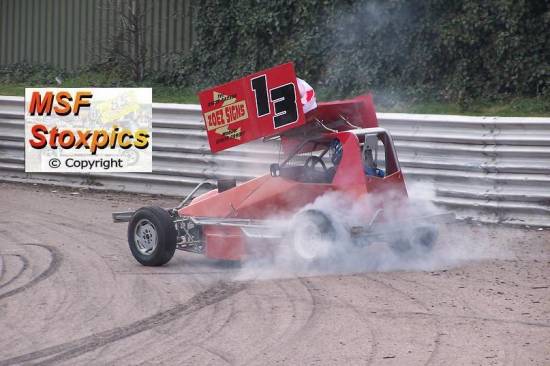 13 Andy Ford got tangled on turn 2 and sets off in a cloud of smoke
