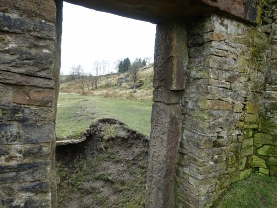 This view through a doorframe shows how the brook has built the land up alongside the bank in times of flood
