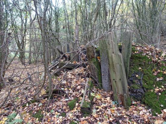 Some old sleepers have been used to shore up an ash tip
