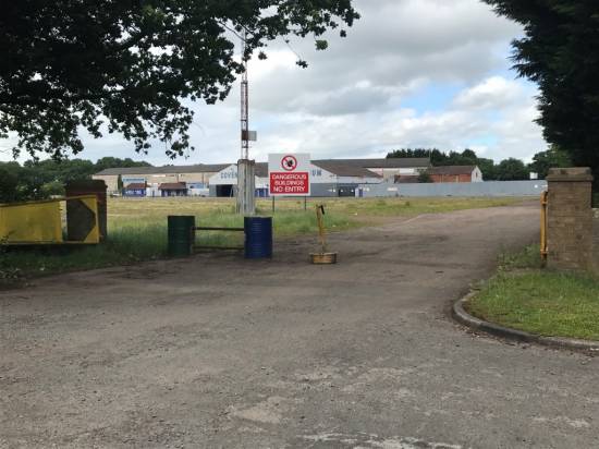 The gate is wide open so any vehicles of any size can drive into the car park.
