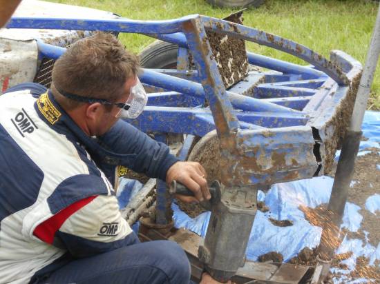 Mark Woodhull repairs damage caused by H228 cutting across his front end resulting in 335 hitting the plating and both cars tangled together.
